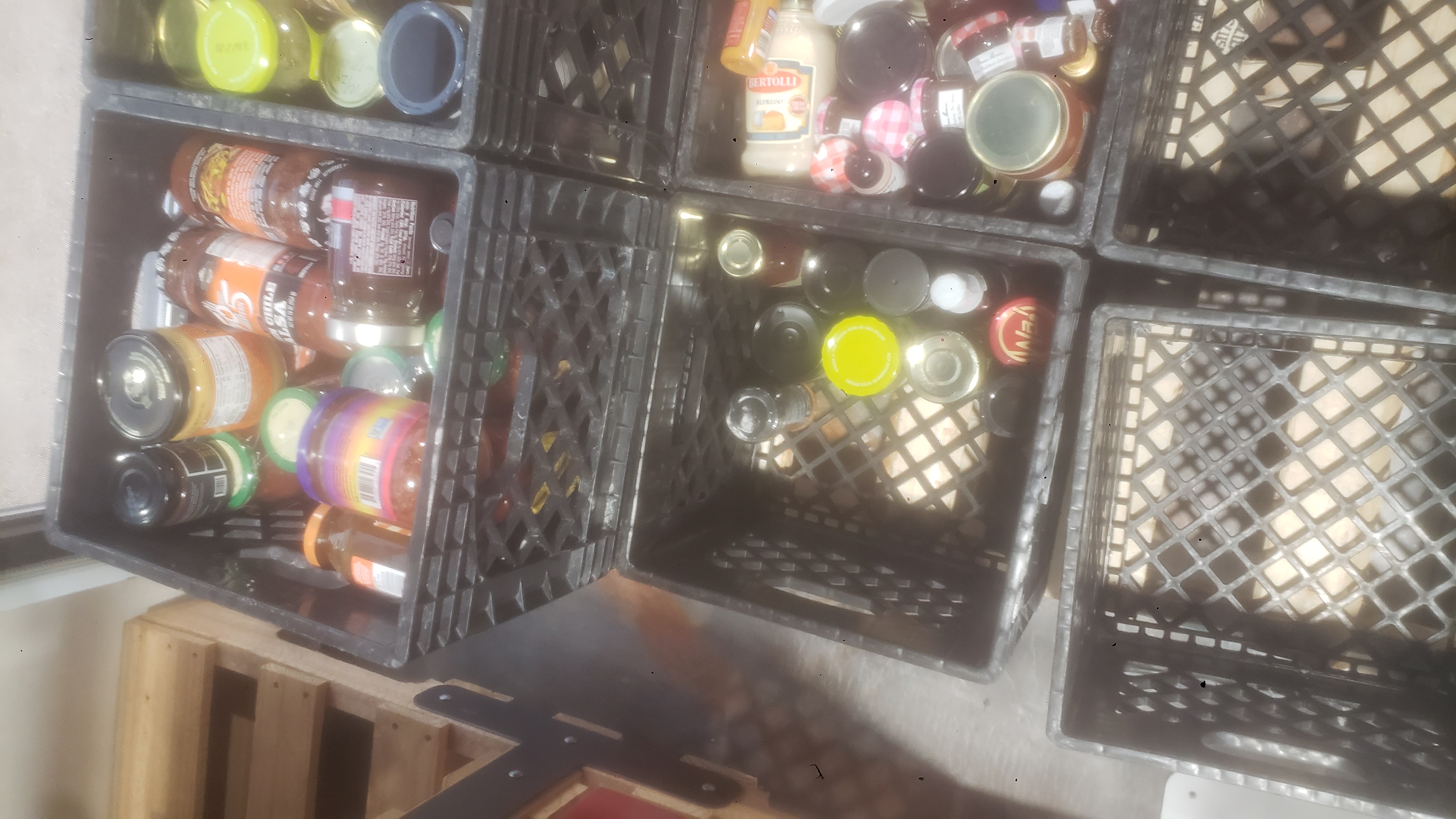 Crates with some filled with glass jars.